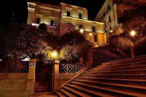 a set of stairs in front of a building at night at San Giorgio Modica Hotel in Modica