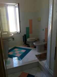 a bathroom with a sink and a toilet at Alphi's Home Nebida in Nebida