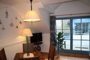 a living room with a tv and a large window at Ferienwohnung Urte in Putgarten , Kap Arkona Rügen in Putgarten