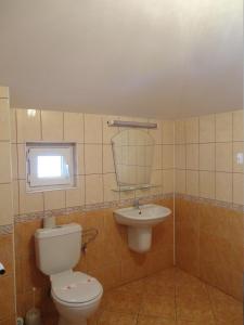 a bathroom with a toilet and a sink at Guest House Rusalka in Sozopol