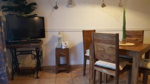 a living room with a tv and a table and a table and chair at Ferienwohnung Finja in Putgarten, Kap Arkona Rügen in Putgarten