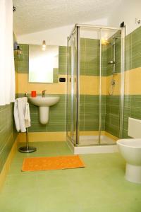 a bathroom with a shower and a sink and a toilet at Villa Marogna in Alghero