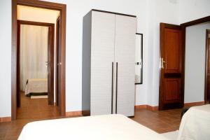 a bedroom with a white closet and a bed at Villa Marogna in Alghero