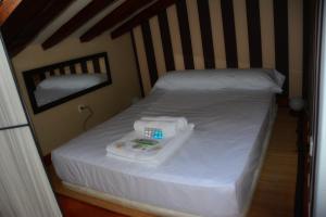a small bed with white sheets and medicines on it at For You Rentals Madrid City Center - Puerta del Sol COR2 in Madrid