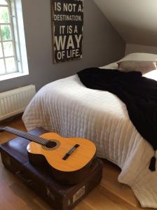 a guitar sitting on a bed in a bedroom at Gothenburg View Apartment in Gothenburg