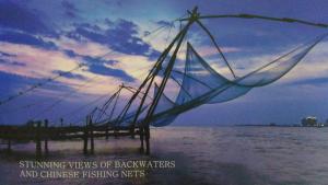 a net in the water next to a pier at i - One's Home Stay in Cochin