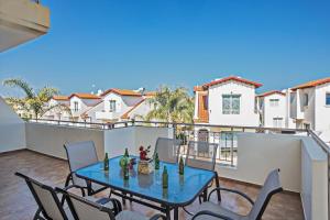 a patio with a table and chairs on a balcony at Orestiada Apartments in Protaras