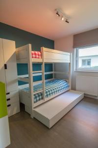 a bedroom with two bunk beds in a room at Villa Moya in Nieuwpoort