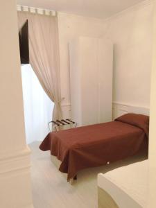 a bedroom with a bed and a television and a window at i principi.bb in Foggia