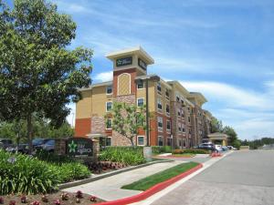 a building with a clock tower in a parking lot at Extended Stay America Suites - Orange County - Yorba Linda in Anaheim