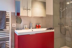 a bathroom with a red sink and a shower at Chambres d'Hôtes Rachelle Schneider in Husseren-les-Châteaux +64 photos