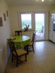 a dining room with a table and chairs and a window at Ferienhaus Charme in Grabowhöfe