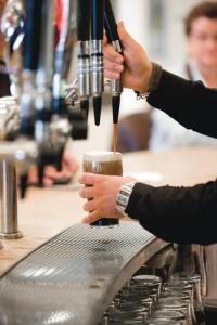 a person is making a drink on a machine at Riu Plaza The Gresham Dublin in Dublin