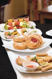 three plates with different types of food on a table at Riu Plaza The Gresham Dublin in Dublin