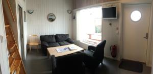 a living room with a couch and a table at Arctic Seasport in Løding