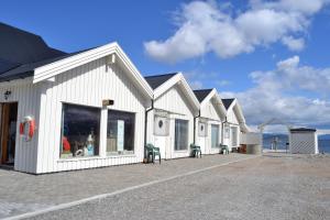 a white building with a lot of windows at Arctic Seasport in Løding +9 photos