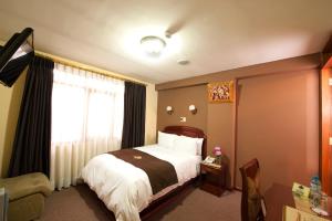 Postel nebo postele na pokoji v ubytování Hotel Mabey Cusco