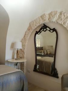 a bedroom with a large mirror on the wall at Tenuta del Lauro in Locorotondo