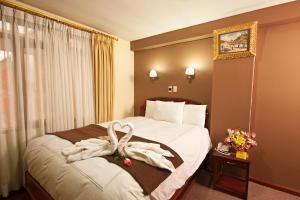 Postel nebo postele na pokoji v ubytování Hotel Mabey Cusco