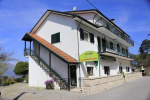 a large white building with a sign on it at Alojamento Local Lindo Verde in Vieira do Minho