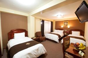 Postel nebo postele na pokoji v ubytování Hotel Mabey Cusco