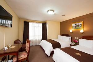 Postel nebo postele na pokoji v ubytování Hotel Mabey Cusco