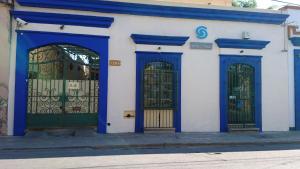 a blue and white building with two gates at Hostal Mixteco Naba Nandoo in Oaxaca City