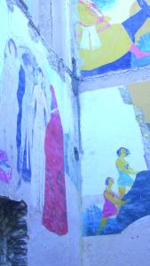 a wall with a painting of people on it at Residenza d'Epoca Borgodifiume in Fiumefreddo Bruzio