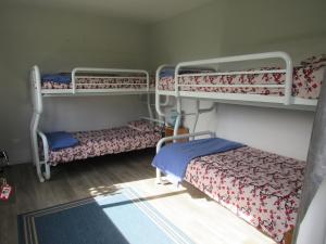 a room with two bunk beds and a bed at White Elephant Accomodation in Motueka