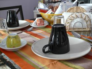 a table with plates and utensils on a table at B&B LA Garzetta in Adria +36 photos