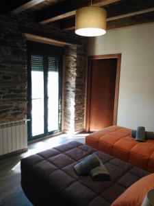 a bedroom with two beds and a large window at Albergue Pension Porta Santa in Baleira