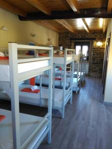 a group of bunk beds in a room at Albergue Pension Porta Santa in Baleira