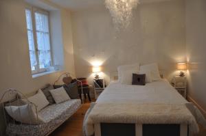 a bedroom with a large bed and a couch at La marionnette du plateau in Lyon