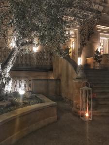 a room with a tree and stairs with lights at Hotel Villa del Bosco in Catania