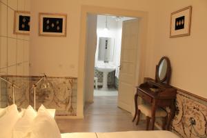 a bedroom with a mirror and a desk and a sink at Lisbon Downtown Inn in Lisbon