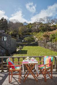 a table and two chairs sitting on a patio at Casa do Vale do Sossego in Capelas