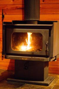 a stove with a fire inside of it at Mt Glorious Getaways in Mount Glorious