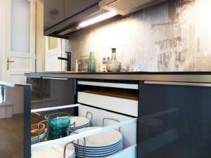 a kitchen with some dishes in an open refrigerator at Apartment 43 in Budapest