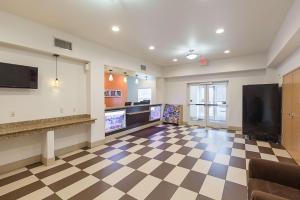 a large room with a checkerboard floor and a kitchen at Motel 6-Fort Worth, TX in Fort Worth