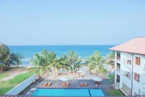 a view of the ocean from the balcony of a resort at Cardamon Hotel Nilaveli in Nilaveli