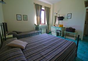 a bedroom with two beds and a window at Portasirena Agriturismo in Paestum