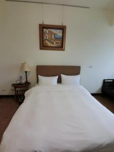 Postel nebo postele na pokoji v ubytování Long Zhi Yue Hotel