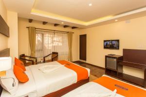 Krevet ili kreveti u jedinici u okviru objekta Hotel Jay Suites