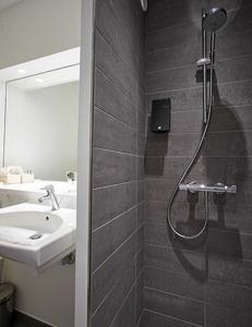 a bathroom with a shower and a sink at Haraldskær Sinatur Hotel & Konference in Vejle +41 photos