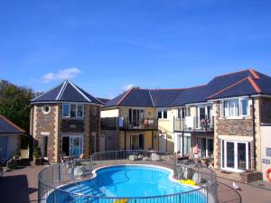 a large apartment complex with a large swimming pool at Porth Veor Manor Villas & Apartments in Newquay