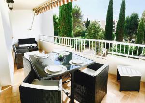 a dining table and chairs on a balcony with a view at Le Diodon De Sagone in Sagone