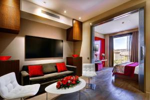 a living room with a couch and a bed at Olivia Plaza Hotel in Barcelona