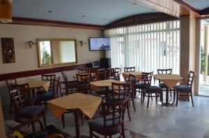 a restaurant with tables and chairs in a room at Philippos Hotel in Paralia Katerinis