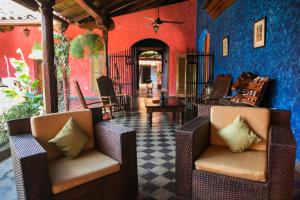 a living room with two chairs and blue walls at Hotel Casa del Consulado in Granada