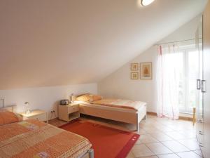 1 dormitorio con 2 camas y ventana en Haus Hartmann, Ferienwohnungen Sonnenseite en Wasserburg